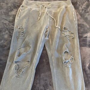 NSF distressed grey sweatpant with holes and banded bottom.